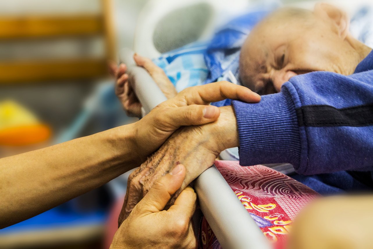 Holding the Hand of an Elderly Patient